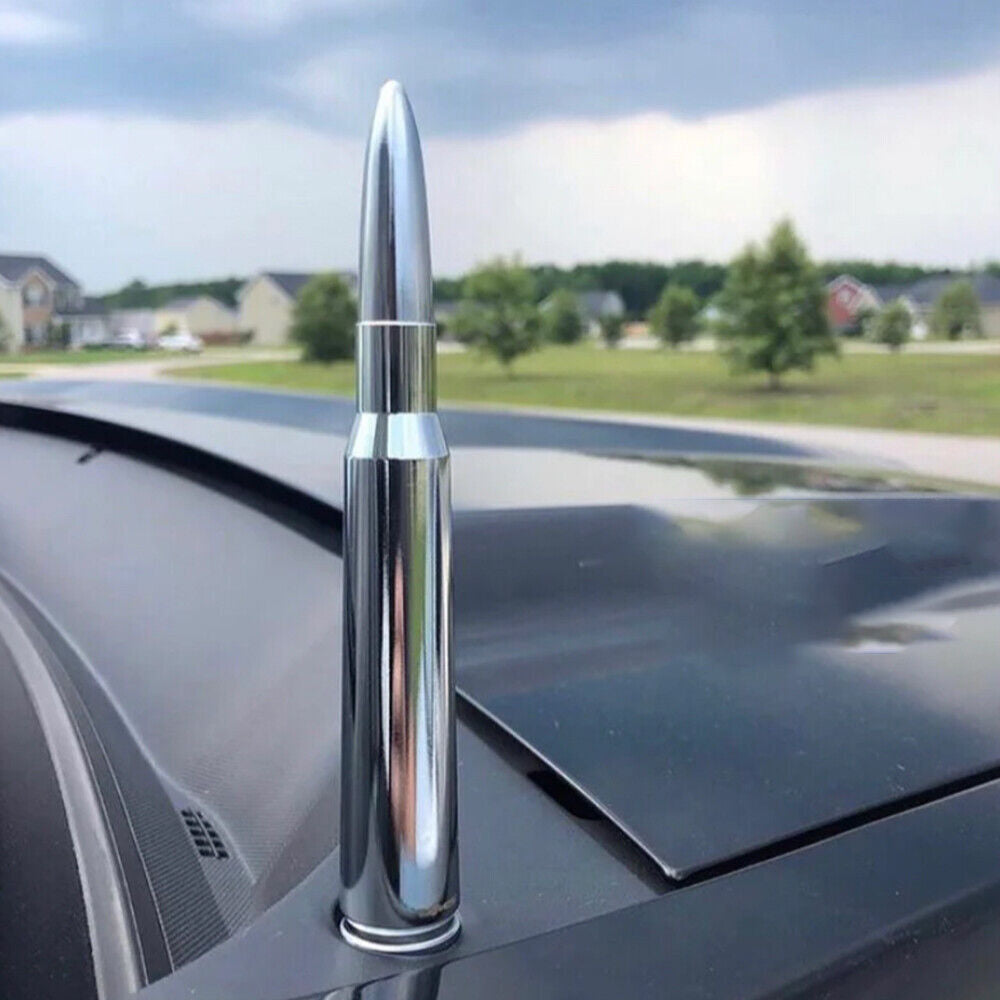 Chrome bullet-shaped antenna on a car roof with a suburban background